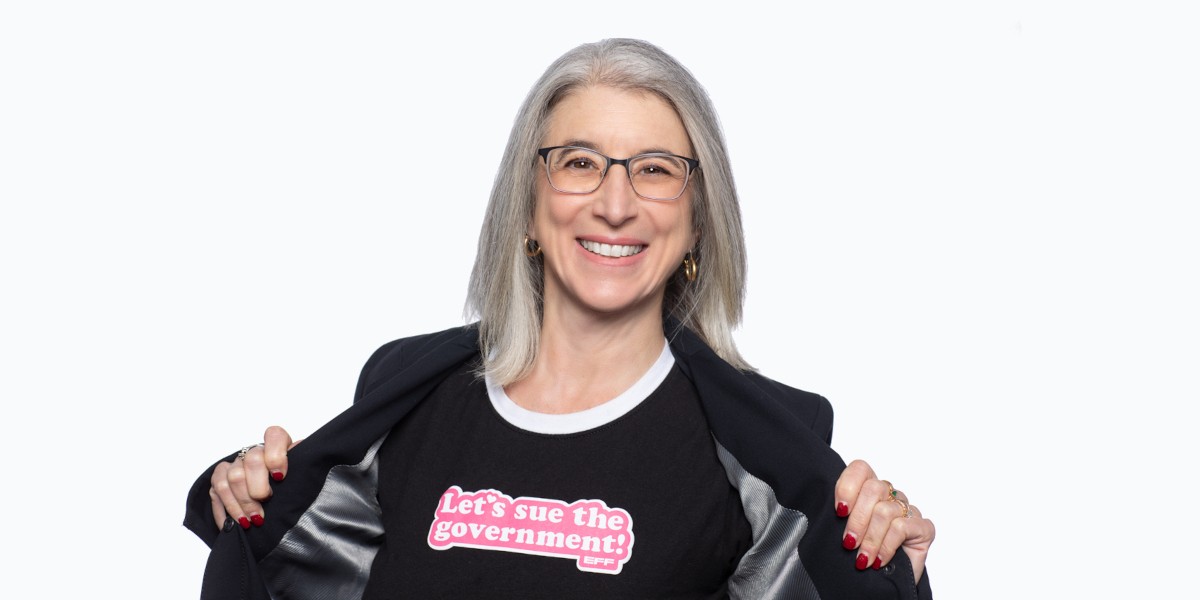 Cindy Cohn wearing a t-shirt that says Let's Sue the Government